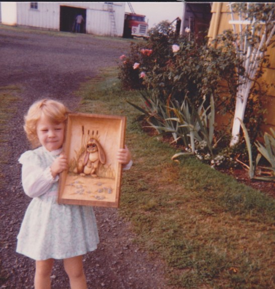 Little Paige posting with a gift for me from Grandpa--a carving of Leo the Lop, from a series of books that I loved.